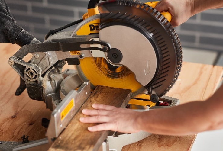 Person using a mitre saw