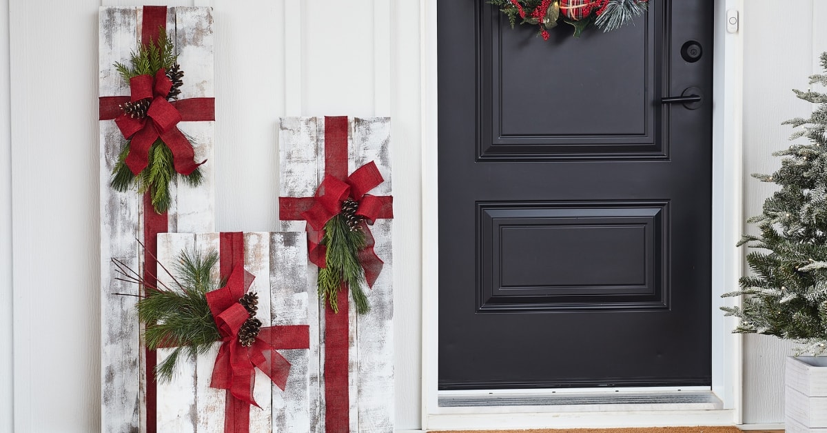 Large wooden Christmas presents on a porch