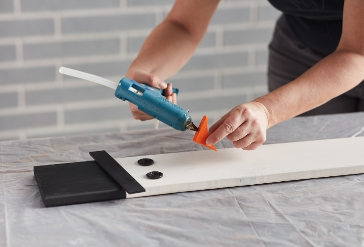 Person using a hot glue gun