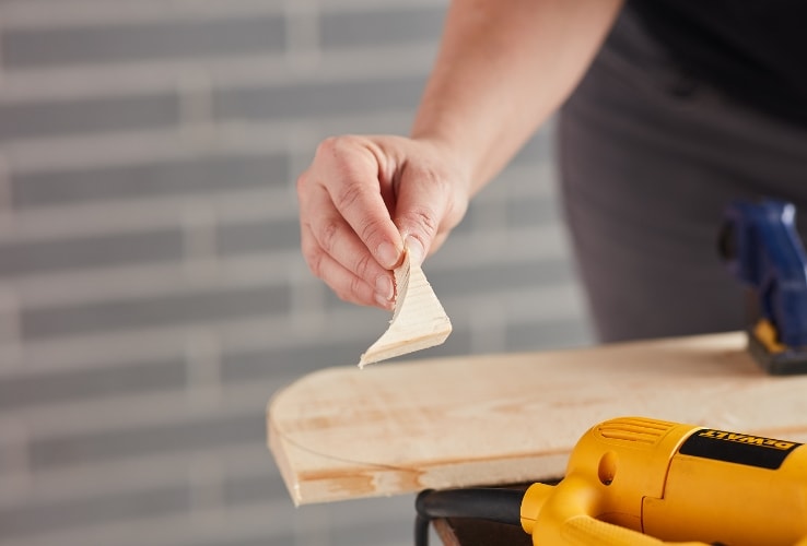 Person holding a small scrap of wood