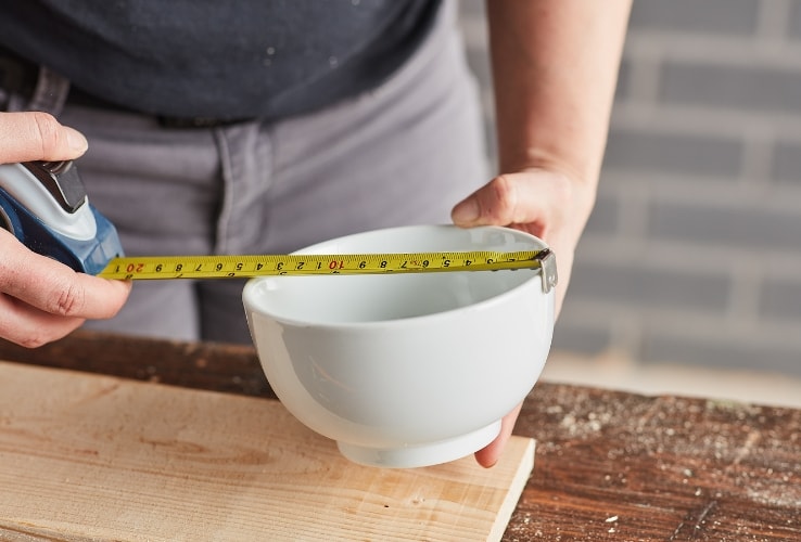 Person measuring a bowl