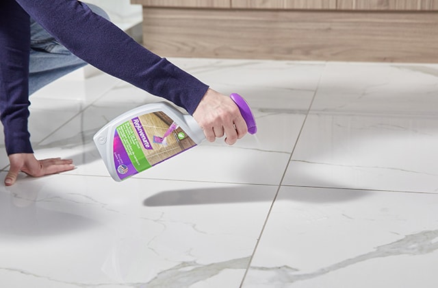 Person pouring a cleaning product on a ceramic floor