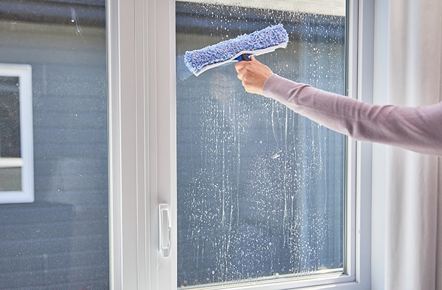 Person cleaning a windowpane