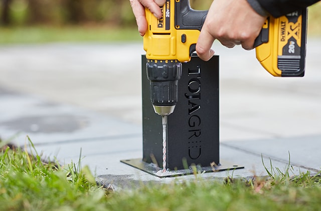 Person predrilling holes with a drill