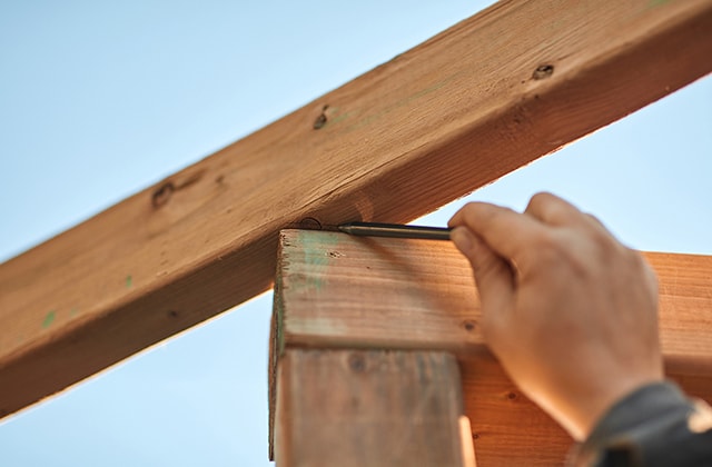 Person tracing a cut angle with a pencil