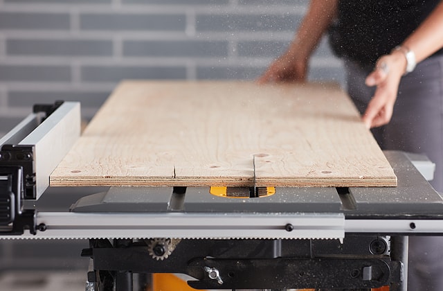 Person cutting a plywood sheet