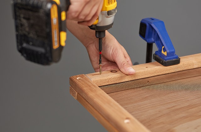 Person assembling a wooden door