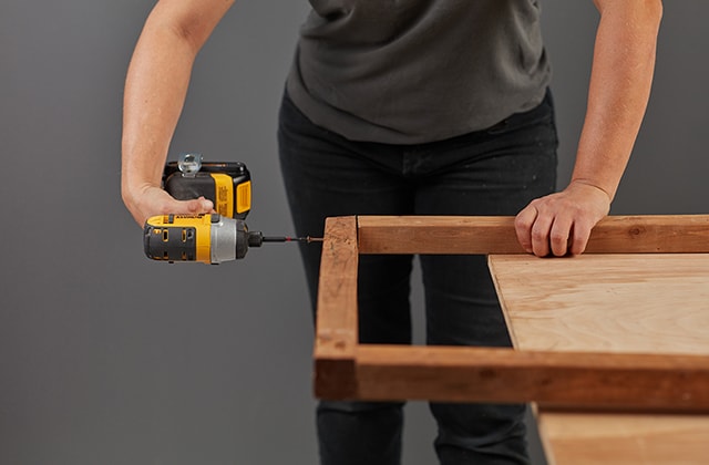 Person assembling wooden frames