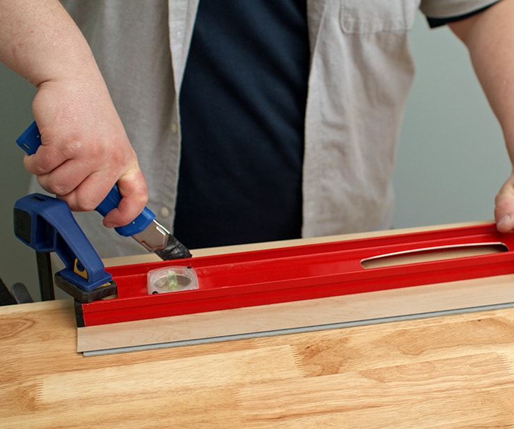 Person cutting a vinyl plank