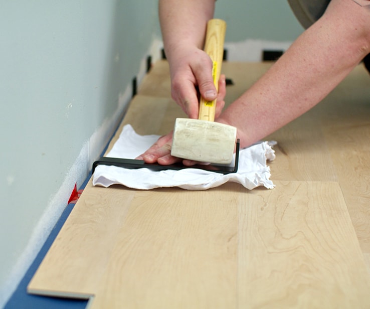 Person installing a vinyl plank