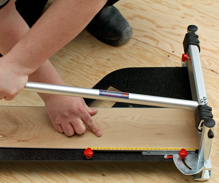 Person using a laminate cutter