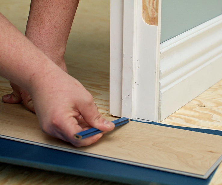 Person trimming a door frame