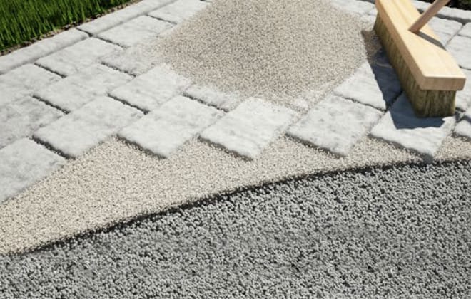 Brush and polymeric sand over patio stones