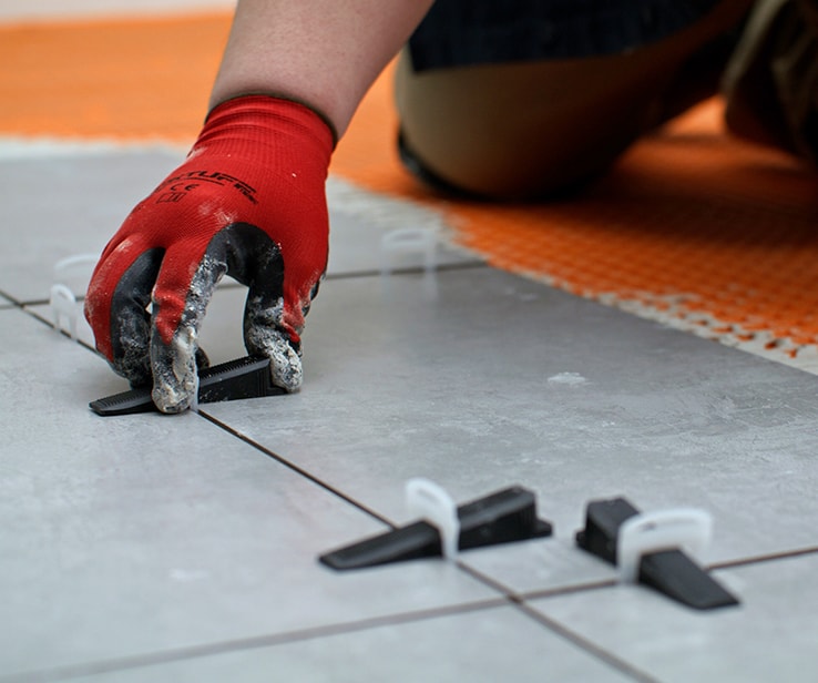 Person placing a levelling wedge