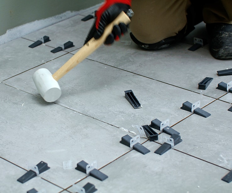 Person using a rubber mallet