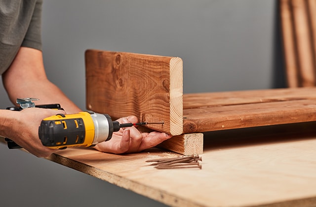 Person building a flower box