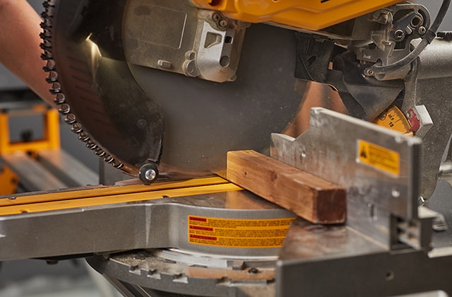 Person cutting pieces of wood