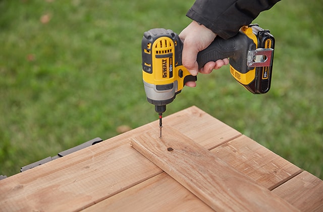 Person assembling sandbox doors