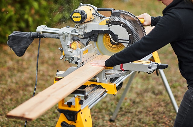 Person cutting 1x6 wood pieces