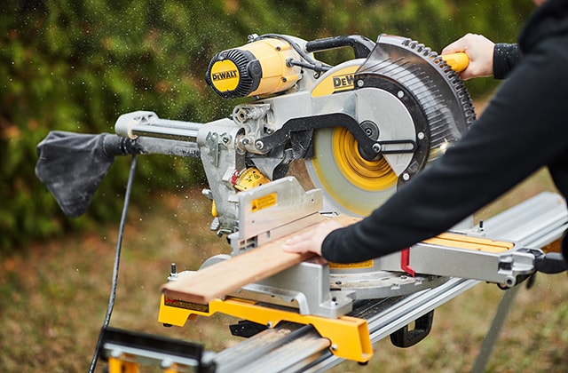 Person cutting 1x4 wood pieces