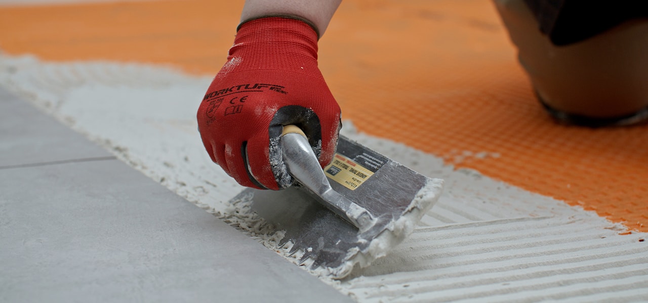 Man laying floor tiles