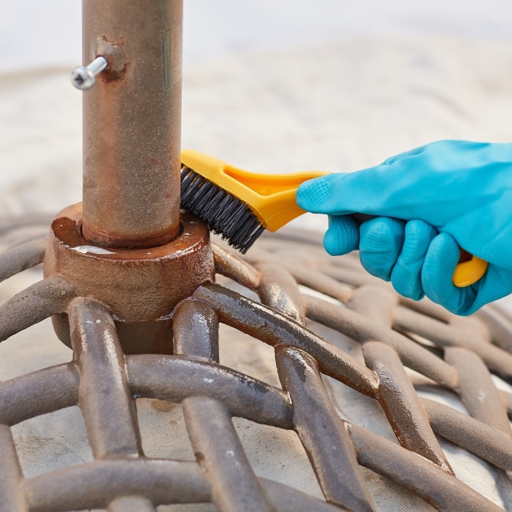 Person refinishing an umbrella stand