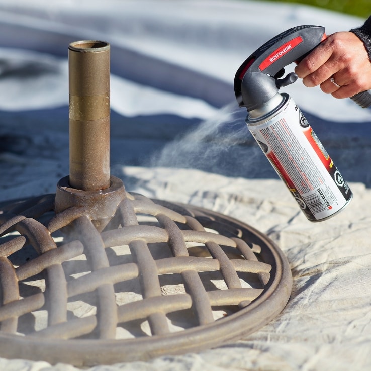 Person refinishing an umbrella stand