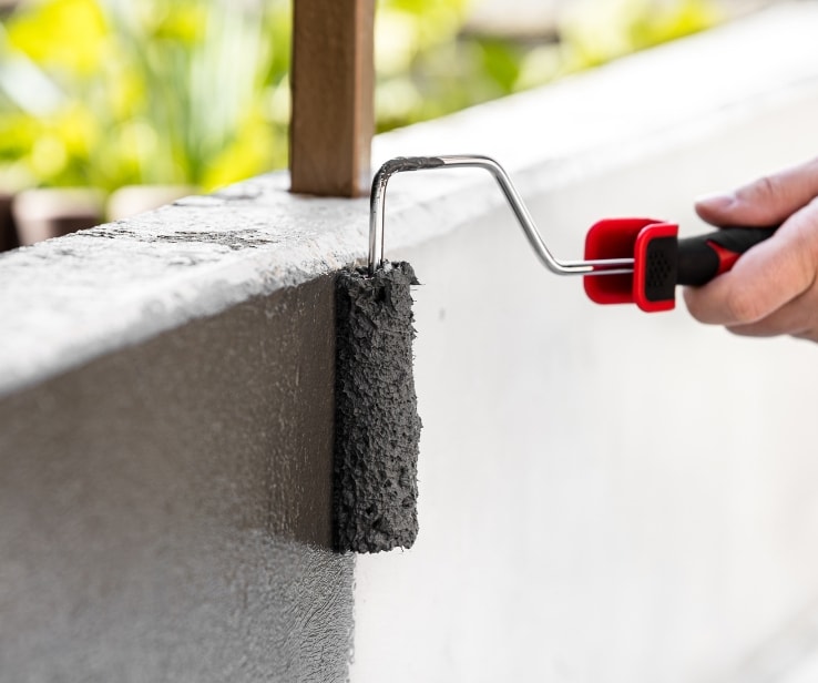 Person painting a concrete surface