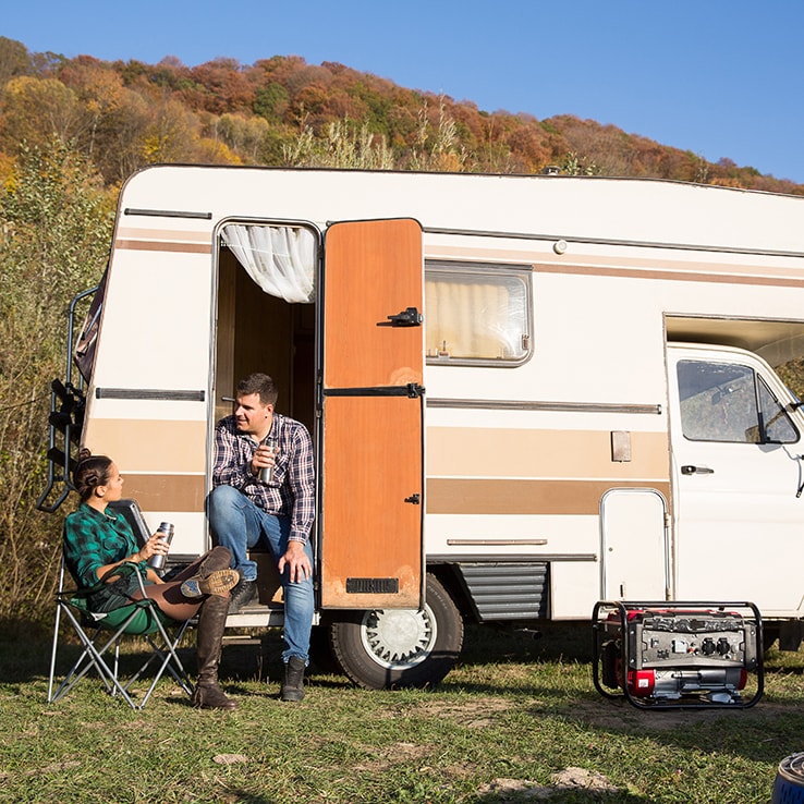 Couple with a camper van and a generator