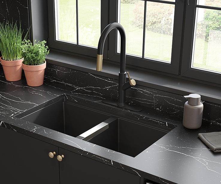 Matte black kitchen faucet with brass accents