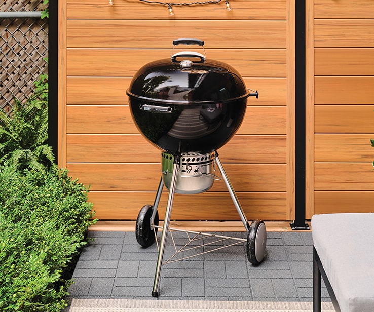 A charcoal BBQ on a patio