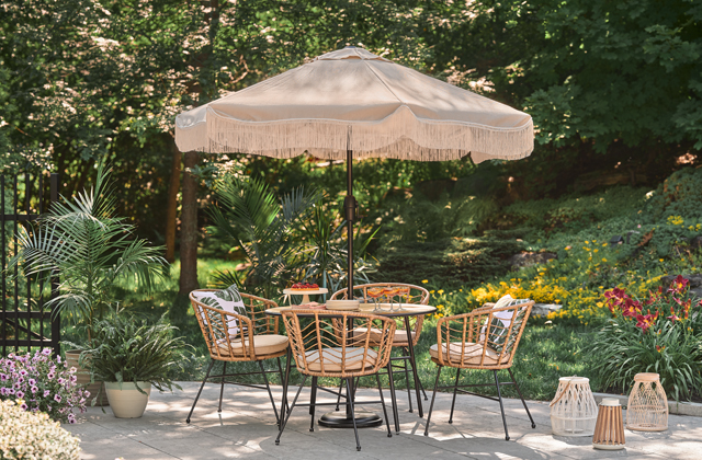 Patio set with an orange umbrella beside a pool