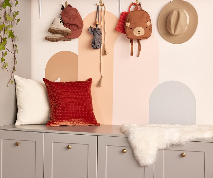 Grey cabinets with pillows and a fluffy throw