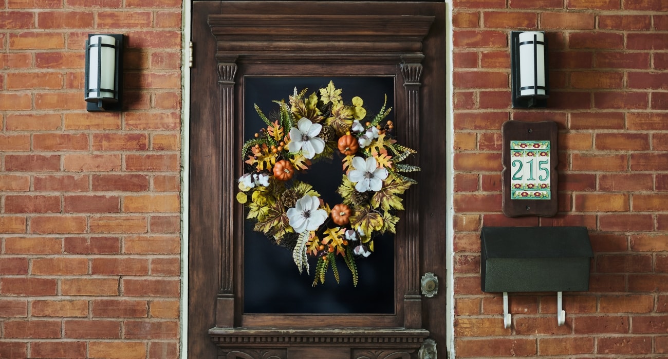 Wooden front door with a fall wreath